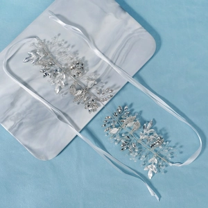 Macro detail of silver bridal hair vine with marquise rhinestones and white pearls