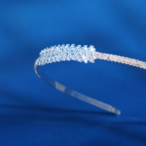Elegant silver bridal headband featuring marquise cut crystals on a deep blue backdrop