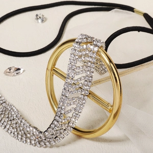 Detailed close-up of luxurious gold metal ring and sparkling rhinestones on the headband