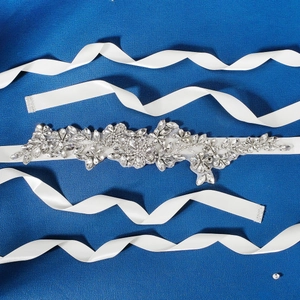 Exquisite bridal wedding sash with sparkling crystal flowers on a white satin ribbon belt