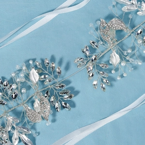 Detailed macro view of silver bridal headband with intricate rhinestones and white pearls