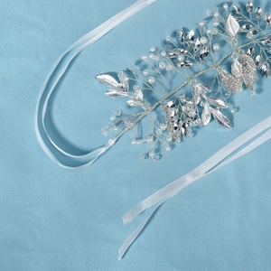 Detailed close-up of handmade bridal hair vine with silver leaves, pearls and crystals
