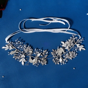 Handmade bridal headband with silver leaf wire, rhinestones, and pearls on navy fabric