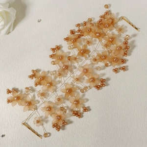 Detailed close-up of handmade bridal headband with acrylic flowers and pearls