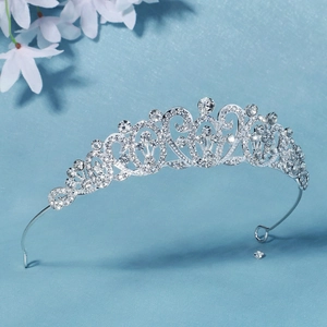 Close-up of silver-toned baroque bridal crown featuring crystal rhinestones and vine patterns