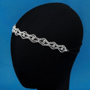 Detailed view of rhinestone headband with wavy chain design and elastic band closure