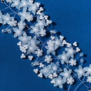 Detail of bridal hair vine with frosted white acrylic flowers and silver wire beads