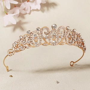 Close-up of golden baroque crown with intricate filigree and sparkling rhinestones