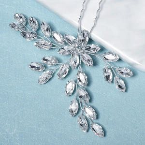 Close-up of handmade bridal hair fork with marquise rhinestones and silver wire leaves
