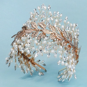 Dettaglio fascia da sposa con foglie dorate, perle bianche e cristalli scintillanti
