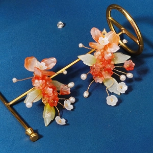 Traditional Chinese bridal hair clips with red resin flowers and white pearls on gold wire