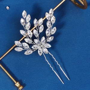 Detailed close-up of handmade bridal hair fork with marquise rhinestones and leaf design