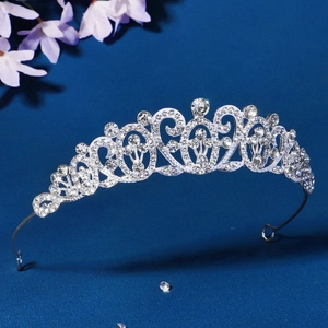 Elegant vintage bridal crown tiara with sparkling rhinestones on deep blue backdrop