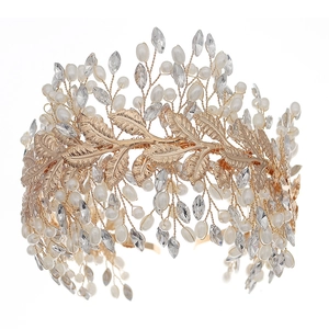 Golden bridal headband with handmade pearls, rhinestones and leaf elements on white background