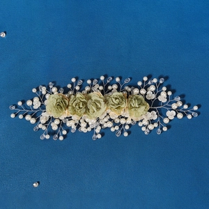 Detail of bridal floral headband with silver wire, green fabric roses and faux pearls