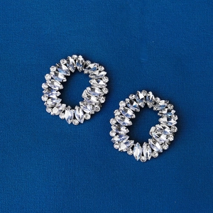 Macro view of bridal shoe buckles featuring marquise and round cut rhinestones in silver