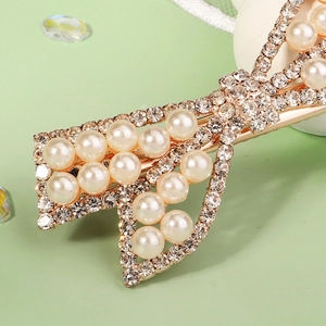 Pince à cheveux élégante en métal doré avec nœud, strass brillants et perles blanches