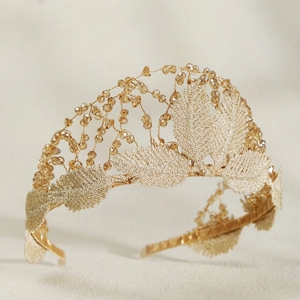 Detail of golden embroidered leaves and amber beads on a forest style bridal tiara