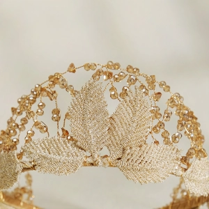 Detailed close-up of handmade gold leaf bridal headband with champagne crystal beads