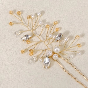Detailed close-up of handmade gold wire hair pin with pearls and crystal accents