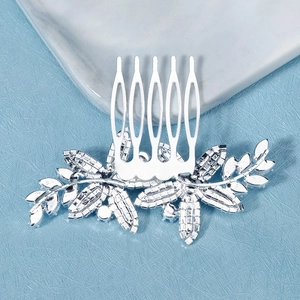 Detailed close-up of a silver zircon hair comb with floral rhinestone patterns