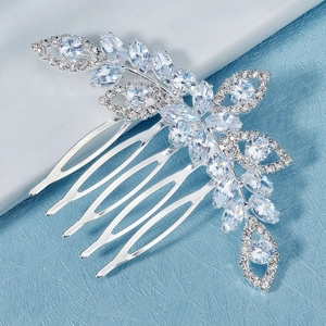 Macro detail of luxury bridal hair comb with silver flower shape and zircons