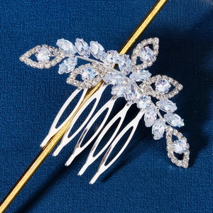 Elegant silver bridal hair comb with floral zircon crystals on deep blue background