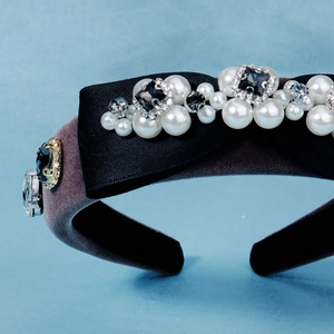 Close-up of padded velvet headband featuring hand-sewn pearls and rhinestones