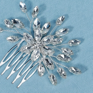 Macro detail of bridal hair comb featuring marquise-cut rhinestones and silver wiring