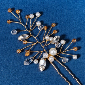 Handmade Chinese style bridal hair pin with pearls and gold wire branches on blue background