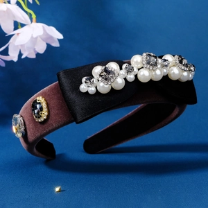 Luxurious velvet headband with satin bow, pearls and rhinestones on blue background