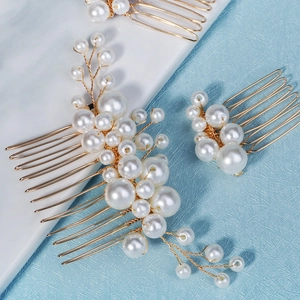 Detail of handcrafted gold wire bridal hair comb set with elegant white pearls