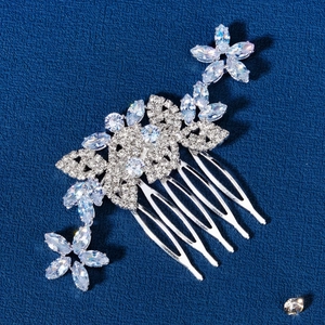 Close-up of bridal floral hair comb with sparkling marquise zircons on a blue texture