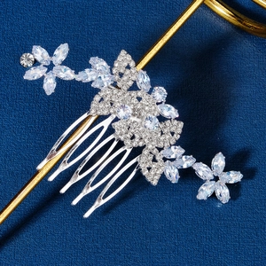 Detail of silver floral bridal hair comb with cubic zirconia petals and butterfly