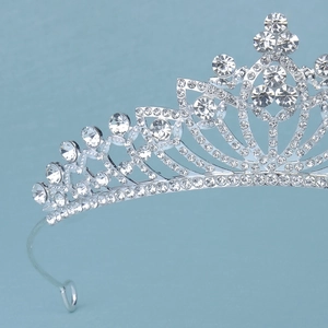 Detailed close-up of hollowed-out silver bridal tiara with sparkling crystal rhinestones