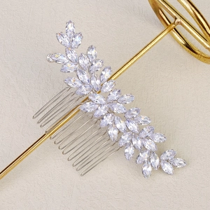 Detail of silver bridal hair comb with marquise cut zircon leaves on a metal stand