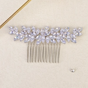 Detailed close-up of a silver floral hair comb with marquise-cut rhinestones and metal teeth