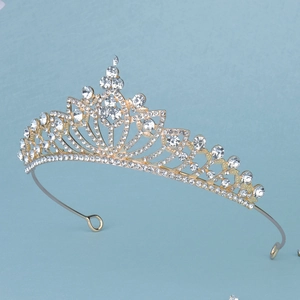 Detailed view of radiant golden tiara with hollow petals and sparkling rhinestones