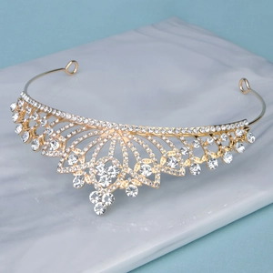 Detailed macro view of the gold hollow design and sparkling white rhinestones on the crown