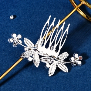 Silver bridal hair comb with cubic zirconia flowers and leaves on navy background
