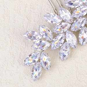 Detailed view of silver hair comb with marquise-cut zircon crystals in a leaf pattern