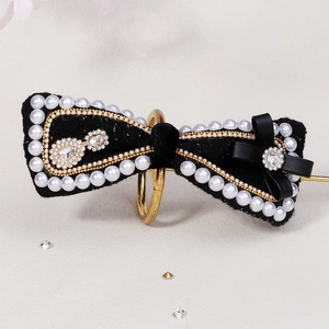 Elegant black velvet bow hair clip with pearl trim and sparkling crystal accents