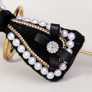 Retro black velvet hair clip with pearls, rhinestones and bow in a vintage design