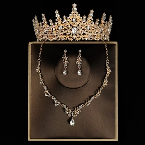 Detailed macro of luxury gold bridal tiara with diamond-cut crystal necklace and earrings