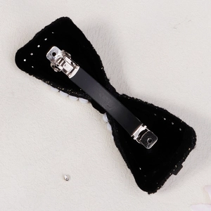 Elegant black velvet bow hair clip with pearls and silver spring fastener for women