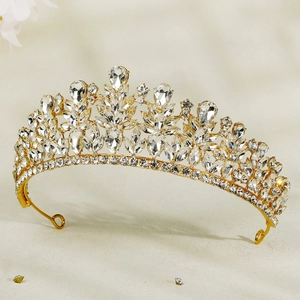 Detailed side view of a gold bridal crown with sparkling crystal rhinestones