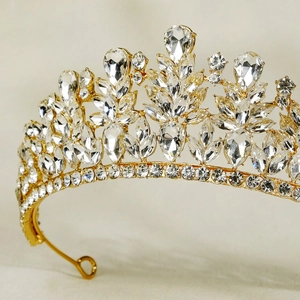 Macro shot of gold wedding crown showing detailed crystal inlay and sparkling rhinestones