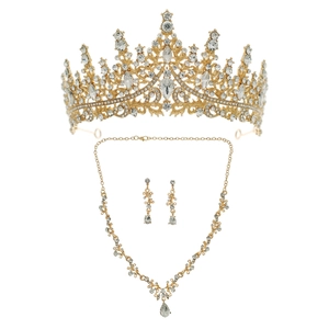 Luxury bridal jewelry set featuring a gold rhinestone crown, necklace, and teardrop earrings