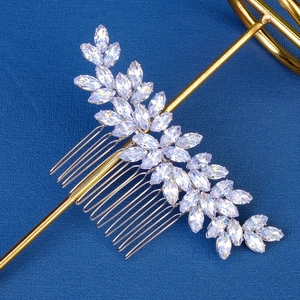 Elegant silver leaf bridal hair comb with marquise-cut rhinestones on blue background