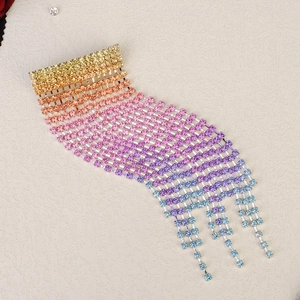Macro view of colorful gradient rhinestone tassel hair clip with sparkling crystal fringe